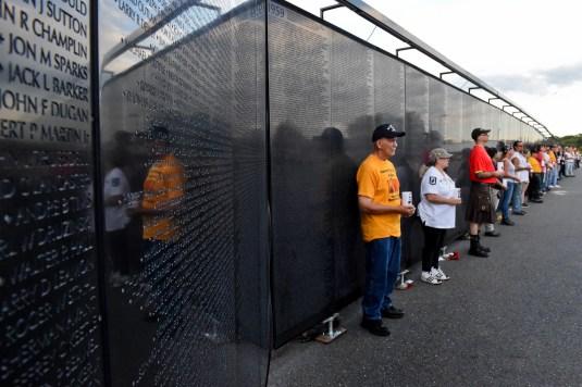 The Wall That Heals, a three-quarter scale replica of the Vietnam Veterans Memorial along with a mobile Education Center, is coming to Kutztown in 2023. Pictured is The Wall That Heals during a candlelight ceremony at Daniel Boone High School in 2018. (File photo - Natalie Kolb, MediaNews Group) “愈合的墙”是越南退伍军人纪念碑的四分之三比例复制品,还有一个移动教育中心,将于2023年来到库茨敦。图为2018年在丹尼尔·布恩高中举行的烛光仪式上的“愈合的墙”。(资料图- MediaNews Group Natalie Kolb)